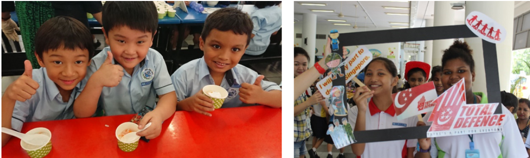 Three young students give thumbs up at a red table; beside them, children pose with a Total Defence photo frame.